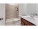 Bathroom featuring a tiled walk-in shower, toilet, and vanity with a bright sink at 238 Lytham Se Dr, Mableton, GA 30126