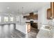 Open-concept kitchen boasts an island, stainless appliances, and dark hardwood floors at 238 Lytham Se Dr, Mableton, GA 30126
