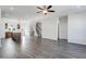 Open-concept living space boasts dark hardwood floors, a ceiling fan, and plenty of natural light at 238 Lytham Se Dr, Mableton, GA 30126