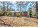 Brick house with backyard, mature trees and grassy area at 2839 Allegro Nw Dr, Atlanta, GA 30318