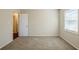 Cozy bedroom with carpet, door to hallway and window at 2839 Allegro Nw Dr, Atlanta, GA 30318