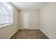 Simple bedroom with carpet, window, and closet at 2839 Allegro Nw Dr, Atlanta, GA 30318