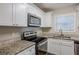 Modern kitchen with granite countertops and stainless steel appliances at 2839 Allegro Nw Dr, Atlanta, GA 30318