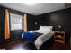 Dark-painted bedroom with a queen bed and wood shelf at 516 Arthur Sw St, Atlanta, GA 30310