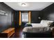 Dark-painted bedroom with a queen bed and wood chest at 516 Arthur Sw St, Atlanta, GA 30310