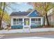 Charming blue house with white trim, front porch, and landscaped yard at 516 Arthur Sw St, Atlanta, GA 30310