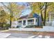 Charming blue house with white trim, front porch, and landscaped yard at 516 Arthur Sw St, Atlanta, GA 30310