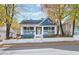 Charming blue house with white trim, front porch, and landscaped yard at 516 Arthur Sw St, Atlanta, GA 30310