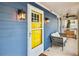 Bright yellow front door with sidelights and porch at 516 Arthur Sw St, Atlanta, GA 30310