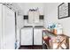 Bright laundry room, washer, dryer, and storage cabinets at 516 Arthur Sw St, Atlanta, GA 30310