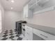 Bright laundry room with ample cabinetry and checkerboard floor at 8120 Tynecastle Dr, Atlanta, GA 30350