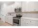 White cabinets, stainless steel appliances, and quartz countertops at 3065 Windover Ln, Kennesaw, GA 30144