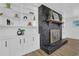 Modern built-in shelving flanking a black brick fireplace with glass doors at 4243 Westbrook Ct, Tucker, GA 30084