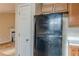 Galley kitchen with a black refrigerator and wooden cabinetry at 90 Lake Avalon Ct, Dallas, GA 30157