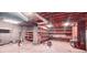 A large unfinished basement with storage and utility shelving and open ceiling at 1030 Lake Haynes Ne Dr, Conyers, GA 30012