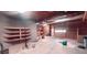 Unfinished basement with shelving, open ceiling, and potential for customization at 1030 Lake Haynes Ne Dr, Conyers, GA 30012