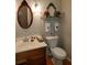 Well-lit bathroom features a wooden vanity with a white sink and classic fixtures at 1030 Lake Haynes Ne Dr, Conyers, GA 30012