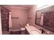 Bathroom vanity with granite countertop, tile shower and bronze fixtures at 1030 Lake Haynes Ne Dr, Conyers, GA 30012