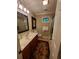 Functional bathroom featuring a vanity with drawers, shower, and a decorative rug at 1030 Lake Haynes Ne Dr, Conyers, GA 30012