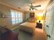 Comfortable bedroom with a ceiling fan and window with shutters at 1030 Lake Haynes Ne Dr, Conyers, GA 30012