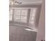 Bedroom with a bay window and plantation shutters providing lots of natural light at 1030 Lake Haynes Ne Dr, Conyers, GA 30012