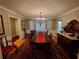 Bright dining room with long table, chandelier, and bay window at 1030 Lake Haynes Ne Dr, Conyers, GA 30012