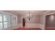 Dining room featuring wainscoting, hardwood floors, and an elegant chandelier at 1030 Lake Haynes Ne Dr, Conyers, GA 30012