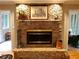 Close up of living room with a stone fireplace and hearth with view into an adjacent sunroom at 1030 Lake Haynes Ne Dr, Conyers, GA 30012
