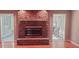 Close-up of stone fireplace with hearth and adjacent sunrooms at 1030 Lake Haynes Ne Dr, Conyers, GA 30012
