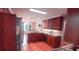 Kitchen with cherry cabinets, granite countertops, and stainless steel appliances at 1030 Lake Haynes Ne Dr, Conyers, GA 30012