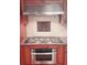 This kitchen features wooden cabinets, granite countertops, a glass cooktop, and stainless steel oven at 1030 Lake Haynes Ne Dr, Conyers, GA 30012
