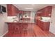 The kitchen features hardwood floors, a granite island, and wooden cabinets at 1030 Lake Haynes Ne Dr, Conyers, GA 30012