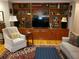 Cozy living room featuring a wooden bookcase, comfortable seating, and a stylish rug at 1030 Lake Haynes Ne Dr, Conyers, GA 30012