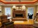 Inviting living room features a stone fireplace, hardwood floors, and access to sunroom at 1030 Lake Haynes Ne Dr, Conyers, GA 30012