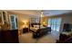 Spacious main bedroom featuring a four-poster bed, neutral decor, and access to the backyard through patio doors at 1030 Lake Haynes Ne Dr, Conyers, GA 30012