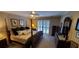 Spacious main bedroom featuring a four-poster bed, neutral decor, and access to the backyard through patio doors at 1030 Lake Haynes Ne Dr, Conyers, GA 30012