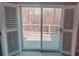 View of deck and trees visible through the sliding glass door and shuttered windows at 1030 Lake Haynes Ne Dr, Conyers, GA 30012