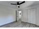 Bedroom with wood-look floors, ceiling fan and hallway access at 2490 Woodfern Ct, Marietta, GA 30062