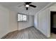 Bright basement bedroom with ceiling fan and grey vinyl flooring at 2490 Woodfern Ct, Marietta, GA 30062