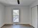 Light-filled bedroom with wood-look floors and large window at 2490 Woodfern Ct, Marietta, GA 30062