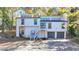 Stunning two-story home with gray and white exterior, attached garage, and landscaping at 2490 Woodfern Ct, Marietta, GA 30062