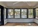 Bright sunroom with multiple windows and wooden floors overlooking backyard at 2490 Woodfern Ct, Marietta, GA 30062