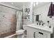 Clean bathroom with white vanity, shower, and toilet at 7108 Roselake Cir, Douglasville, GA 30134