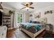 Spacious bedroom with hardwood floors, large bed and ceiling fan at 7108 Roselake Cir, Douglasville, GA 30134