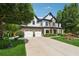 Beautiful two-story home with a three-car garage and manicured lawn at 7108 Roselake Cir, Douglasville, GA 30134