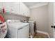 Bright laundry room with ample storage and modern washer/dryer at 7108 Roselake Cir, Douglasville, GA 30134