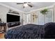 Main bedroom with TV and plush bedding at 7108 Roselake Cir, Douglasville, GA 30134