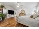 Main bedroom with hardwood floors, large bed, and mounted TV at 7108 Roselake Cir, Douglasville, GA 30134