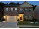 Two-story brick home with a large front yard, illuminated at night at 1797 Weatherbrook Cir, Lawrenceville, GA 30043