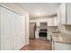 Modern kitchen with white cabinets, granite counters, and stainless steel appliances at 3519 Adkins Nw Rd, Atlanta, GA 30331